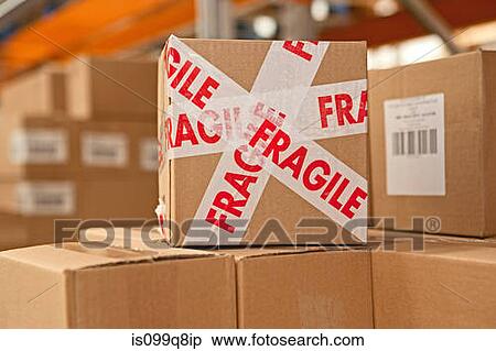 Cardboard box with parcel tape saying fragile View Large Photo Image Stock Photography - Cardboard box with parcel tape saying fragile. Fotosearch