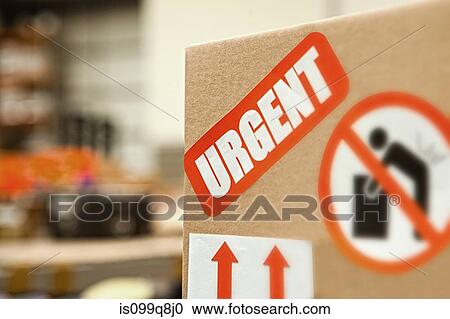 Stock Image - Cardboard box with warning stickers, close up. Fotosearch