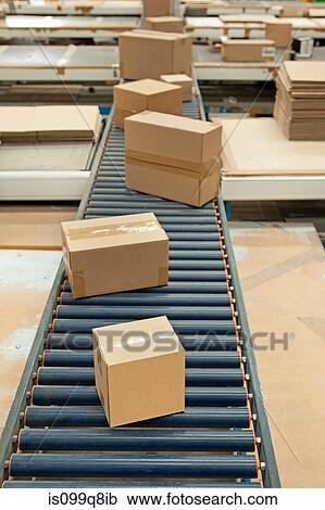 Cardboard boxes on conveyor belt View Large Photo Image Stock Image - Cardboard boxes on conveyor belt. Fotosearch