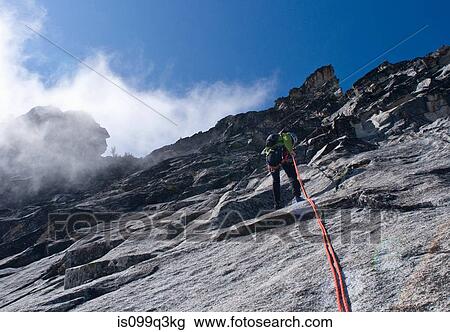 Stock Image - Climber rappelling rock wall, Mount Berge, Cascade Range, Washington, USA. Fotosearch