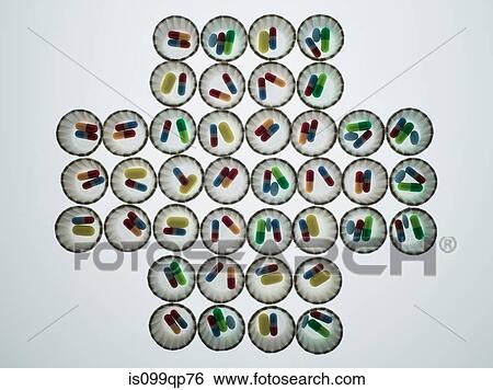 Dispenser cups of pills forming a cross shape View Large Photo Image Stock Photograph - Dispenser cups of pills forming a cross shape. Fotosearch