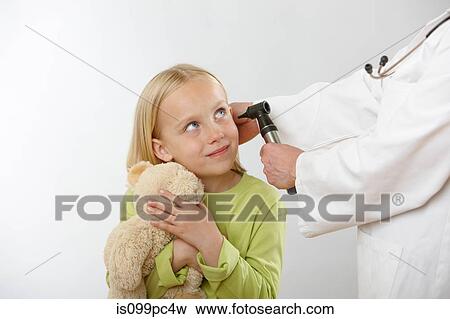 Stock Photo - Doctor examining girl's ear. Fotosearch