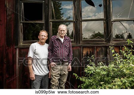 Father and son outside shack, portrait View Large Photo Image Stock Photo - Father and son outside shack, portrait. Fotosearch