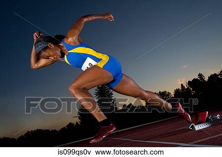Female athlete leaving starting blocks View Large Photo Image Stock Photo - Female athlete leaving starting blocks. Fotosearch