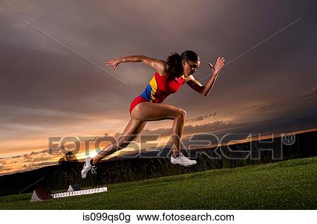 Female athlete moving off from starting blocks View Large Photo Image Stock Image - Female athlete moving off from starting blocks. Fotosearch