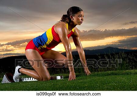 Female athlete on starting blocks View Large Photo Image Stock Image - Female athlete on starting blocks. Fotosearch
