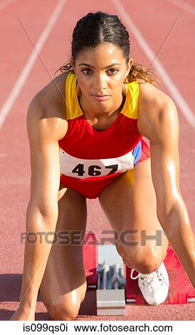 Female athlete on starting blocks View Large Photo Image Stock Image - Female athlete on starting blocks. Fotosearch