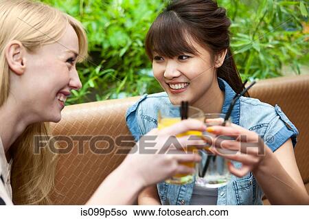 Female friends toasting with soft drinks View Large Photo Image Picture - Female friends toasting with soft drinks. Fotosearch