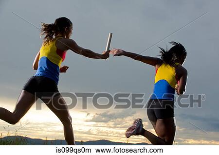 Female relay racers passing baton View Large Photo Image Picture - Female relay racers passing baton. Fotosearch