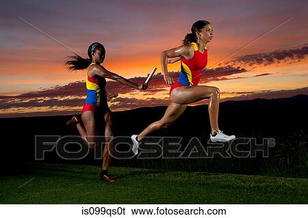 Female relay racers passing baton View Large Photo Image Stock Photograph - Female relay racers passing baton. Fotosearch