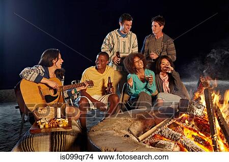 Friends having beach party at night View Large Photo Image Picture - Friends having beach party at night. Fotosearch