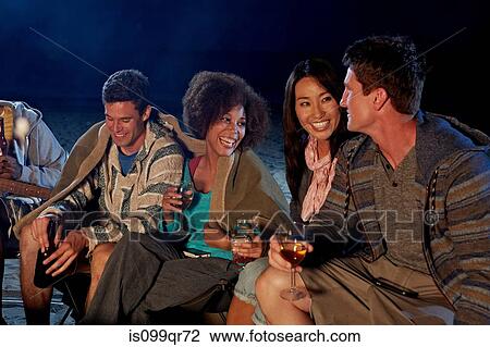 Friends having beach party at night View Large Photo Image Stock Image - Friends having beach party at night. Fotosearch