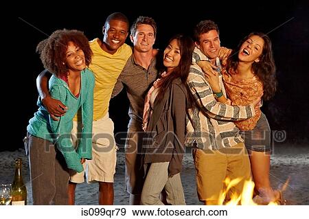 Friends having beach party at night View Large Photo Image Stock Photo - Friends having beach party at night. Fotosearch