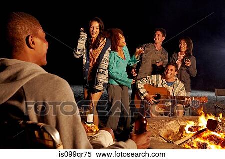 Friends having beach party at night View Large Photo Image Stock Photography - Friends having beach party at night. Fotosearch
