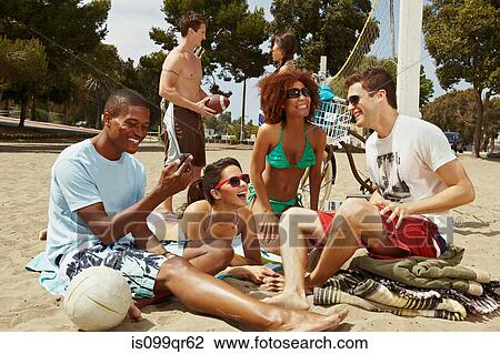 Friends on beach with cell phone View Large Photo Image Stock Image - Friends on beach with cell phone. Fotosearch