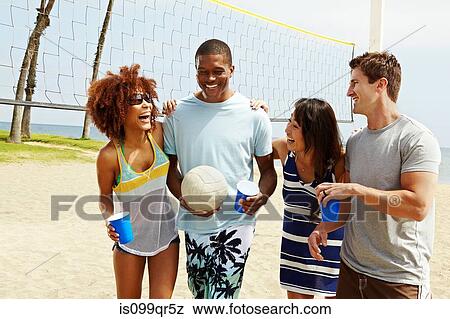 Friends on beach with volleyball and net View Large Photo Image Stock Photo - Friends on beach with volleyball and net. Fotosearch