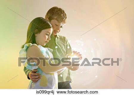 Girl and boy holding lights View Large Photo Image Stock Image - Girl and boy holding lights. Fotosearch