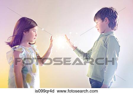 Girl and boy touching bright lights View Large Photo Image Stock Image - Girl and boy touching bright lights. Fotosearch