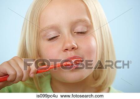 Stock Photograph - Girl brushing teeth. Fotosearch