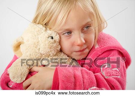 Stock Photo - Girl hugging teddy bear. Fotosearch