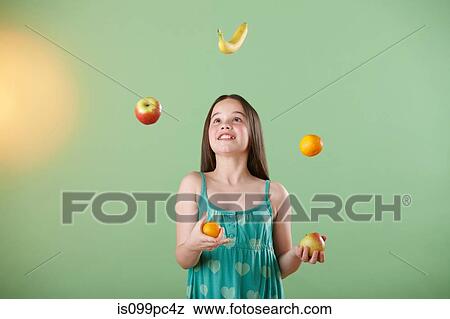 Stock Photo - Girl juggling fruit. Fotosearch