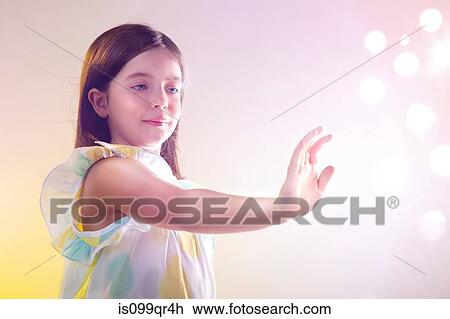Stock Image - Girl reaching out to lights. Fotosearch