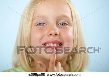 Stock Photo - Girl touching lip. Fotosearch