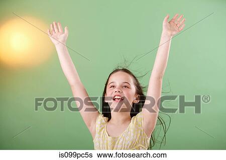 Girl with arms raised View Large Photo Image Stock Photograph - Girl with arms raised. Fotosearch