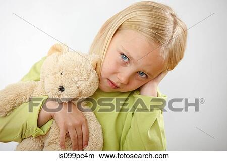 Picture - Girl with teddy covering ears. Fotosearch