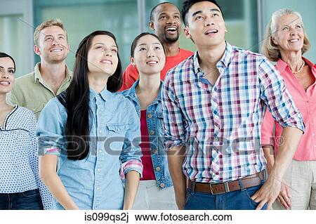 Stock Image - Group of people looking up. Fotosearch
