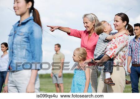 Group of people outdoors, focus on senior woman and family View Large Photo Image Stock Photograph - Group of people outdoors, focus on senior woman and family. Fotosearch