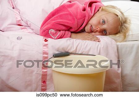 Ill girl in bed with bucket View Large Photo Image Stock Image - Ill girl in bed with bucket. Fotosearch