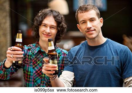 Stock Photo - Male friends posing with beer bottles. Fotosearch