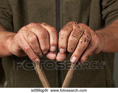 Man leaning with hands on wooden handle View Large Photo Image Stock Photography - Man leaning with hands on wooden handle. Fotosearch