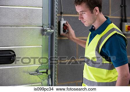 Man opening warehouse doors View Large Photo Image Picture - Man opening warehouse doors. Fotosearch