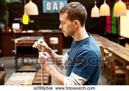 Man playing pool in bar View Large Photo Image Stock Image - Man playing pool in bar. Fotosearch