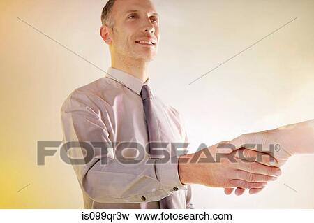 Stock Photo - Man shaking hands. Fotosearch