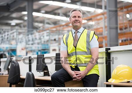 Man sitting on desk in warehouse, portrait View Large Photo Image Stock Photo - Man sitting on desk in warehouse, portrait. Fotosearch
