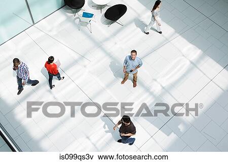Stock Photo - Man standing on office concourse. Fotosearch