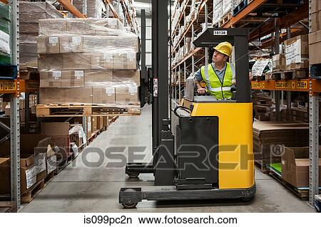 Man transporting stock in distribution warehouse View Large Photo Image Picture - Man transporting stock in distribution warehouse. Fotosearch
