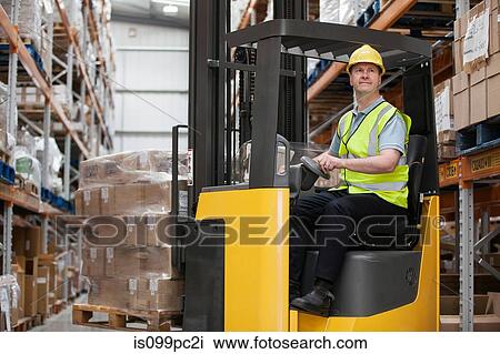 Man transporting stock in distribution warehouse View Large Photo Image Stock Image - Man transporting stock in distribution warehouse. Fotosearch
