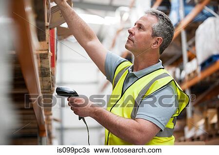 Stock Photograph - Man using barcode reader in warehouse. Fotosearch