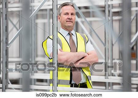 Man with arms folded in empty warehouse, portrait View Large Photo Image Stock Image - Man with arms folded in empty warehouse, portrait. Fotosearch
