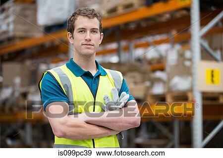 Man with arms folded in warehouse, portrait View Large Photo Image Stock Photo - Man with arms folded in warehouse, portrait. Fotosearch