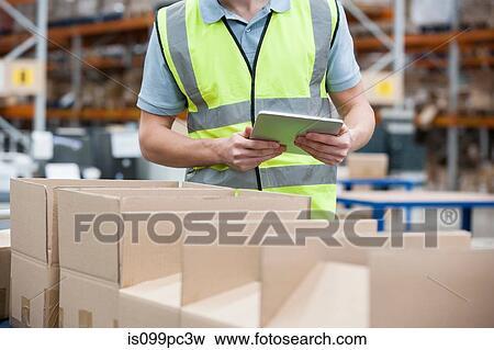 Man with digital tablet and cardboard boxes View Large Photo Image Stock Photo - Man with digital tablet and cardboard boxes. Fotosearch