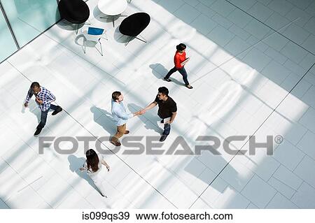 Stock Photo - Men shaking hands on concourse. Fotosearch