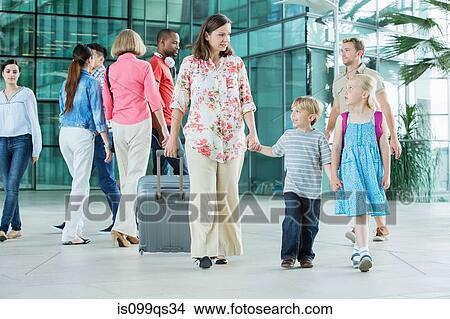 Mother and children walking through airport View Large Photo Image Picture - Mother and children walking through airport. Fotosearch