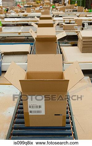 Stock Photo - Open cardboard boxes on conveyor belt. Fotosearch