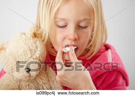 Parent giving daughter medicine View Large Photo Image Stock Image - Parent giving daughter medicine. Fotosearch