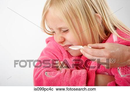 Parent trying to give daughter medicine, girl refusing View Large Photo Image Stock Image - Parent trying to give daughter medicine, girl refusing. Fotosearch